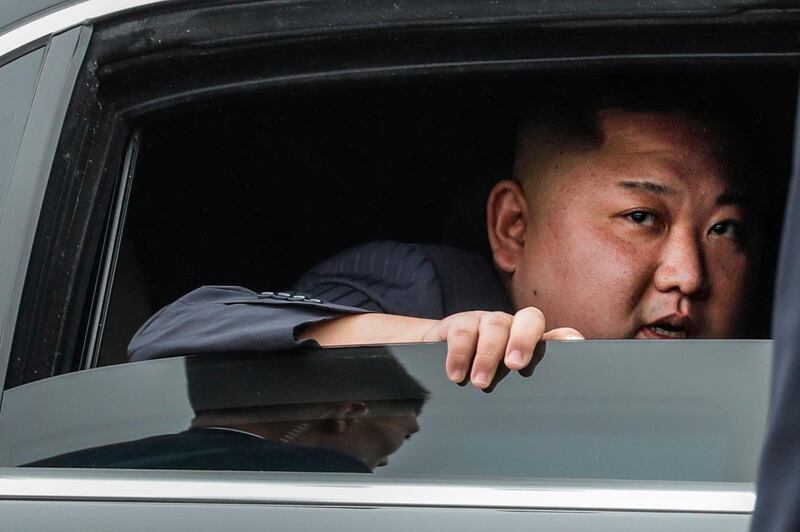 Kim Jong-un looks out from a vehicle as he arrives in Dong Dang. EPA