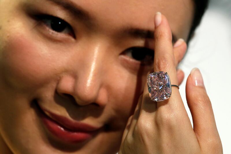 A model poses with a 37.30-carat 'The Raj Pink', the world's largest known fancy intense pink diamond expected to fetch up to $30 million in an upcoming Geneva auction, during a Sotheby's preview in Hong Kong. Bobby Yip / Reuters