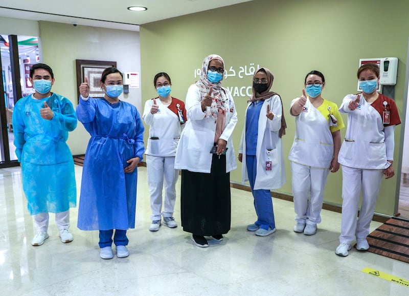 Abu Dhabi, United Arab Emirates, December 13, 2020.   Doctors and UAE residents get Covid-19 vaccinated at the Burjeel Hospital, Al Najdah Street, Abu Dhabi.  Doctors and staff at the vaccination clinic are all thumbs up at the Burjeel Hospital.
Victor Besa/The National
Section:  NA