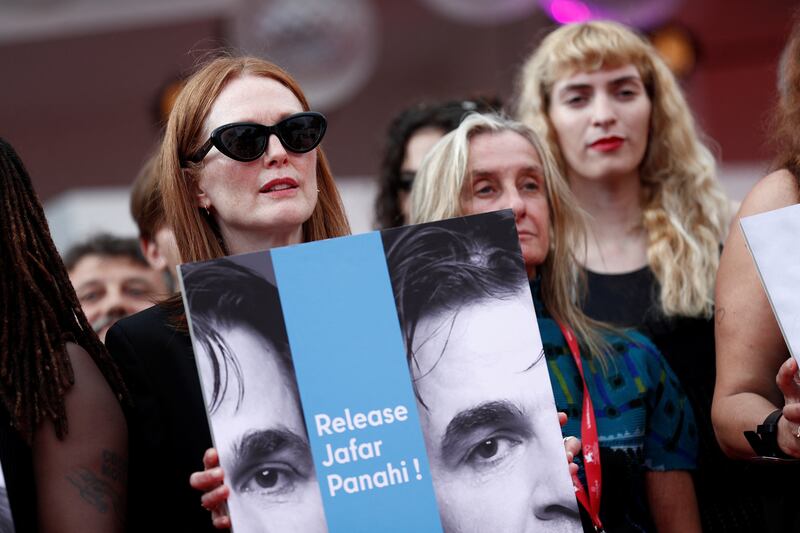 Moore holds a sign calling for Panahi to be released. Getty Images 