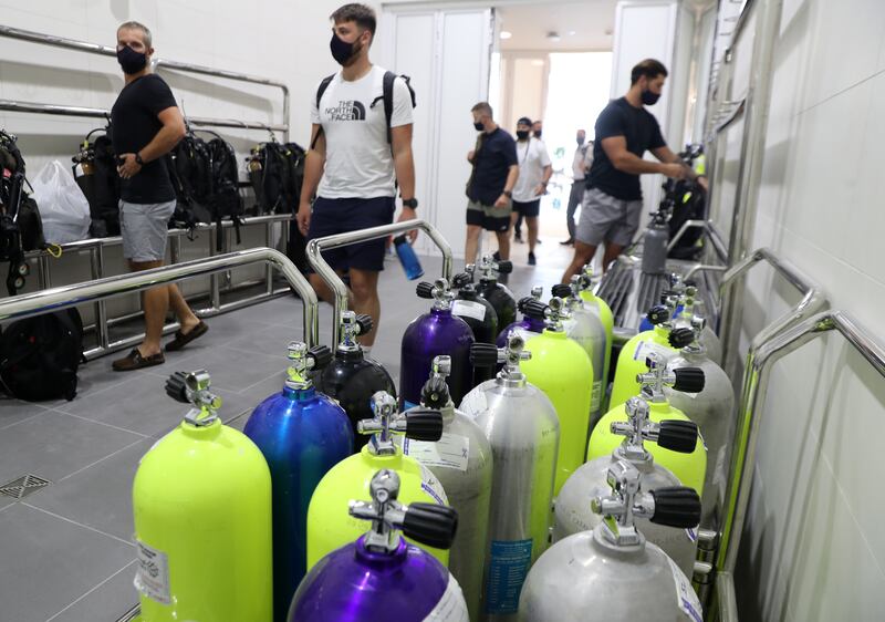 Royal Navy ship divers try out the new Deep Dive Dubai pool.