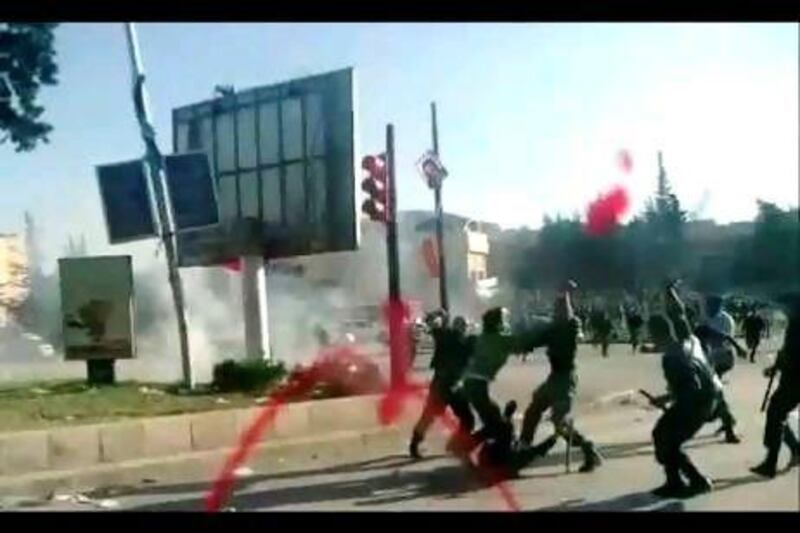 This image grab taken from a video shot through the windscreen of a vehicle and uploaded on YouTube shows Syrian security forces brutally beating students from Aleppo University during a protest on May 17. AFP / YouTube