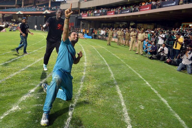 Indian cricketer Yuvraj Singh mimics Usain Bolt's race celebrate after they run a friendly 100-metre sprint on Tuesday following their exhibition cricket match. Manjunath Kiran / AFP