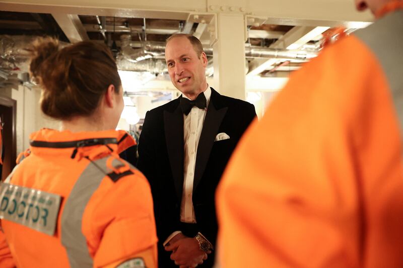Prince William chats with air ambulance pilots, doctors and paramedics. Reuters