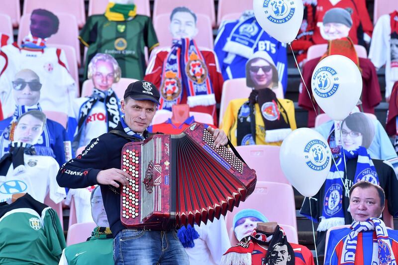 A man plays accordion in front of dummies displayed to replace audience in  Belarus during the match between Dynamo Brest and FC Isloch. AFP