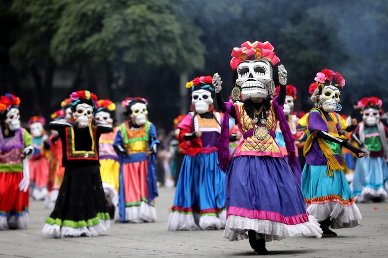 People in costumes join a parade for Day of the Dead celebrations in Mexico City, Mexico. EPA