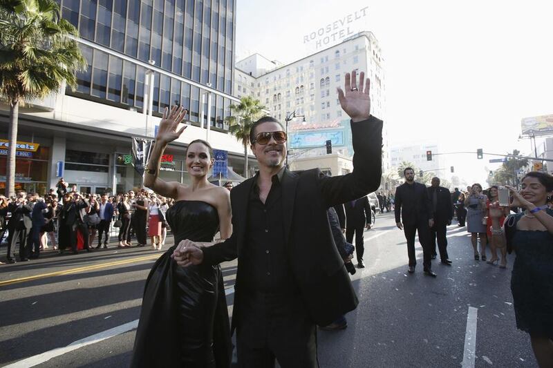 Angelina Jolie and Brad Pitt wave at fans as they arrive at the premiere of Maleficent at El Capitan theatre in Hollywood on Wednesday. Reuters