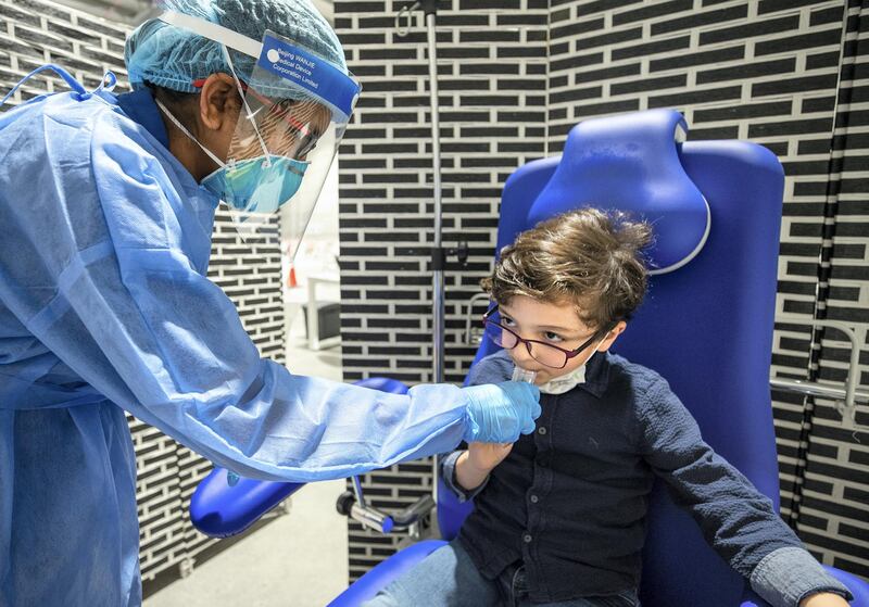 Abu Dhabi, United Arab Emirates, March 18, 2021.  Ryan Al Mulla, six years old, gets saliva tested at the Biogenix lab at G42 in Masdar City.
Victor Besa/The National
Section:  NA
Reporter:  Shireena Al Nowais