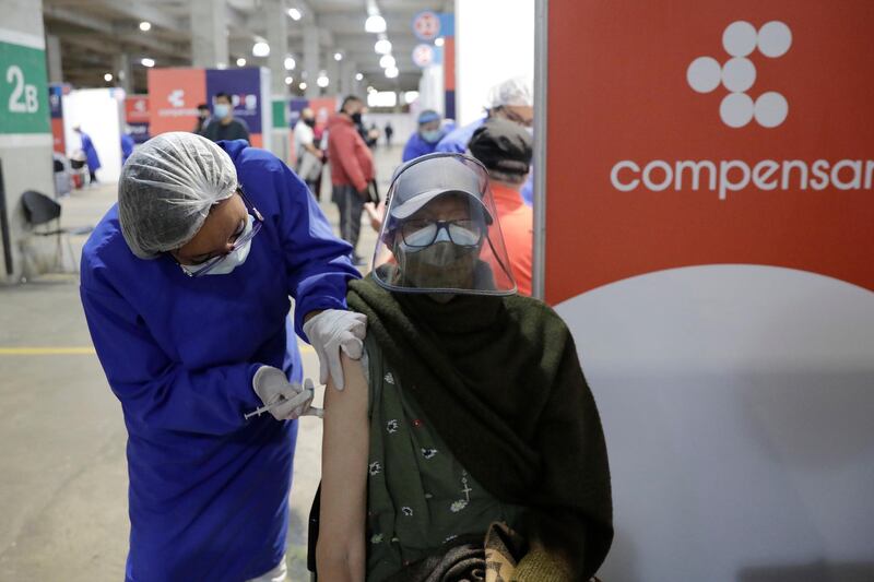 A person receives a vaccine against Covid-19 in Bogota, Colombia. Colombia is experiencing a critical situation owing to a prolonged third wave of the pandemic. EPA