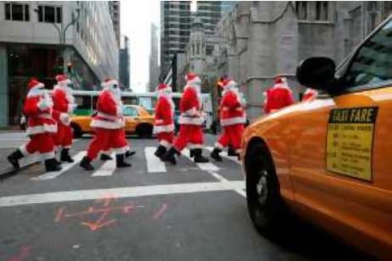 Volunteers of America's "Sidewalk Santas" parade down Fifth Ave. Friday, Nov. 23, 2007 in New York. Volunteers of America is a national, nonprofit, faith-based organization dedicated to helping those in need rebuild their lives and reach their full potential. (AP Photo/Gary He)