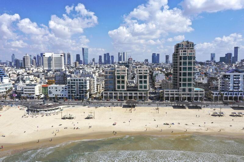 Beachgoers relax on the beach in this aerial photograph taken in Tel Aviv, Israel, on Friday, March 5, 2021. Israel's vaccine campaignÂ raced ahead of the worldÂ after the governmentÂ inked a deal with Pfizer Inc. in exchange for data on the inoculation program. Photographer: Kobi Wolf/Bloomberg via Getty Images