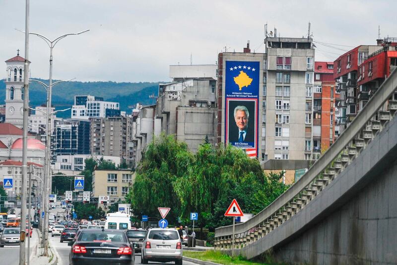 Cars drive past a boulevard named after former US President Bill Clinton in Pristina on June 23. Armend Nimani / AFP