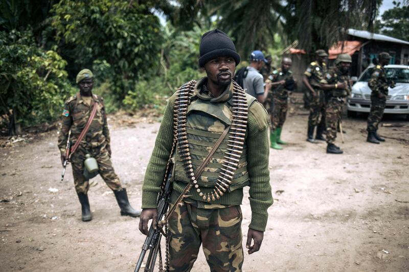 (FILES) In this file photo taken on February 18, 2020 an Armed Forces of the Democratic Republic of Congo (FARDC) soldier takes part in a foot patrol in the village of Manzalaho near Beni, following an attack allegedly perpetrated by members of the rebel group Allied Democratic Forces (ADF). A group of UN experts overseeing sanctions in the Democratic Republic of Congo has warned of a proliferation of homemade bombs in the country's northeast, in an annual report seen by AFP June 15, 2021. / AFP / Alexis Huguet
