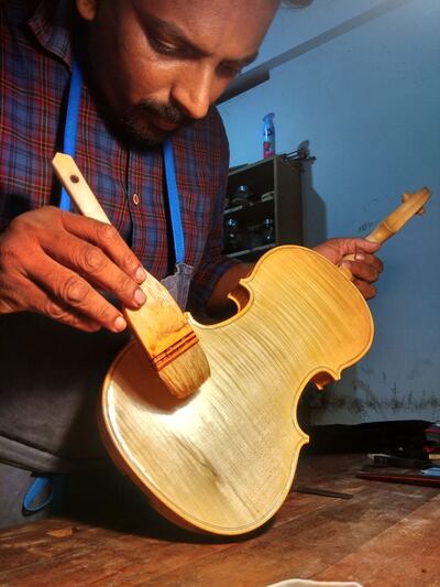 Renjith Leela Chandran at his work desk, crafting a violin from scratch. Photo: Renjith Leela Chandran