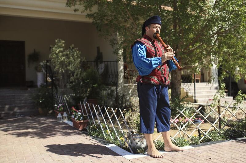 Paul Cooper, a new SCA member, is photographed in a 16th century doublet while playing a recorder, in Abu Dhabi.