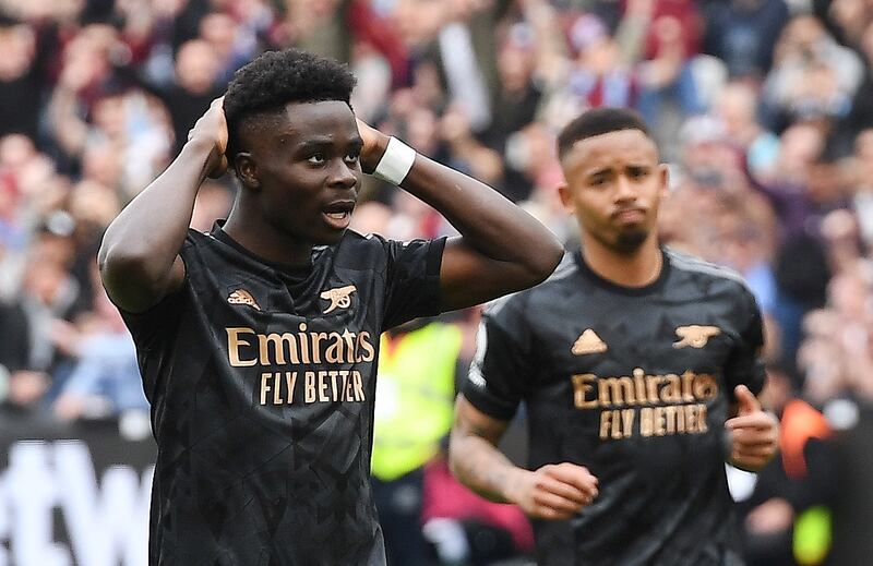 Arsenal's Bukayo Saka (L) reacts after missing a chance to score from the penalty spot during the English Premier League soccer match between West Ham United and Arsenal London in London, Britain, 16 April 2023.   EPA/ANDY RAIN EDITORIAL USE ONLY.  No use with unauthorized audio, video, data, fixture lists, club/league logos or 'live' services.  Online in-match use limited to 120 images, no video emulation.  No use in betting, games or single club / league / player publications