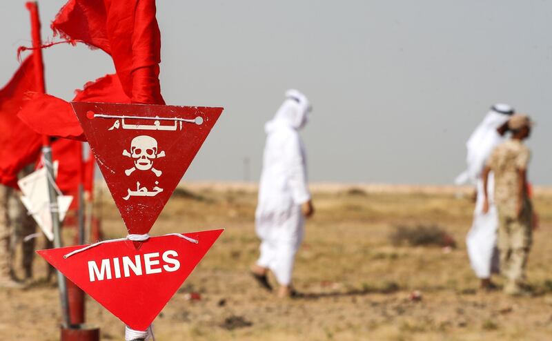 Members of an Emirati delegation visit the mine clearing facility. AFP