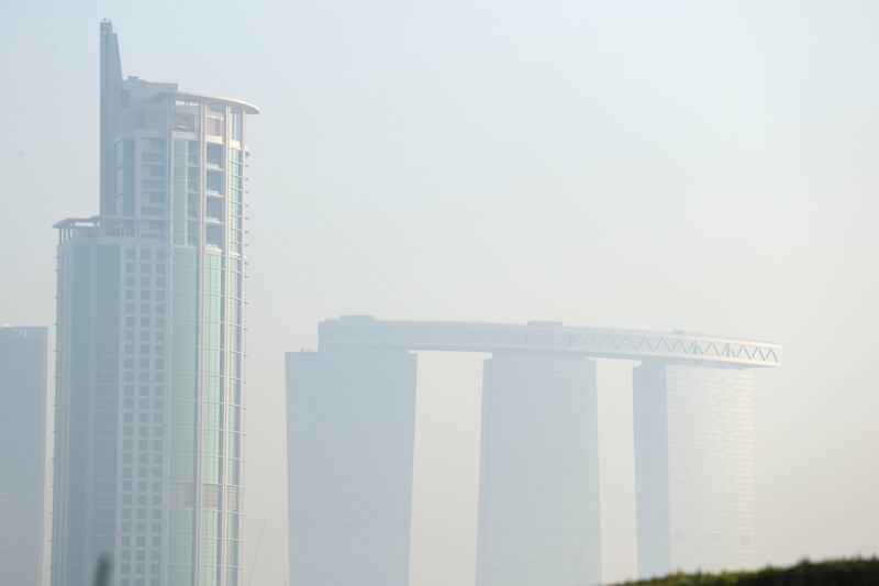 Gate Tower on Al Reem Island, Abu Dhabi, is pictured among the haze. Khushnum Bhandari / The National