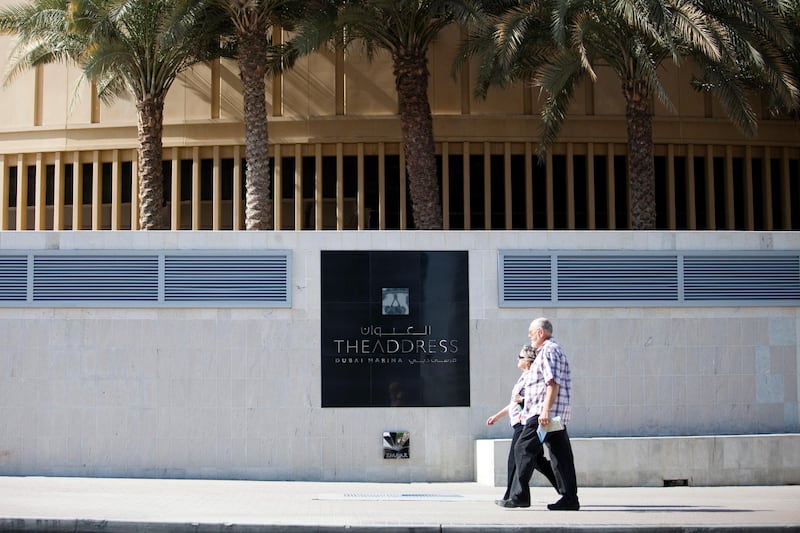 Dubai, Feb 12th, 2012 --  Pedestrians walk by The Address Hotel Dubai Marina on February 12, 2012. (Sarah Dea/ The National)