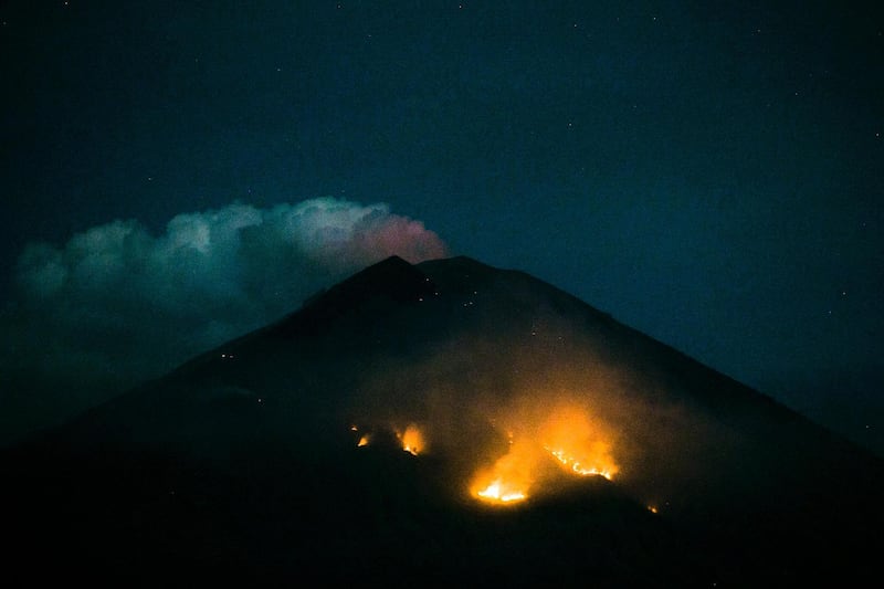 A Forest fire is seen on the slope of Mount Agung volcano after an eruption, as seen from Amed Village in Karangasem, Bali, Indonesia. Made Nagi / EPA