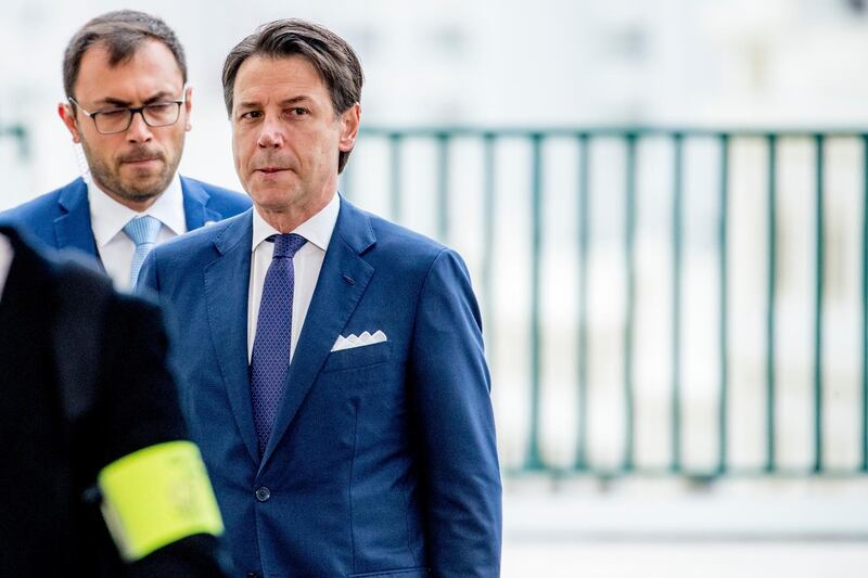 Italian Premier Giuseppe Conte, right, arrives at the G-7 summit in Biarritz, France.  AP