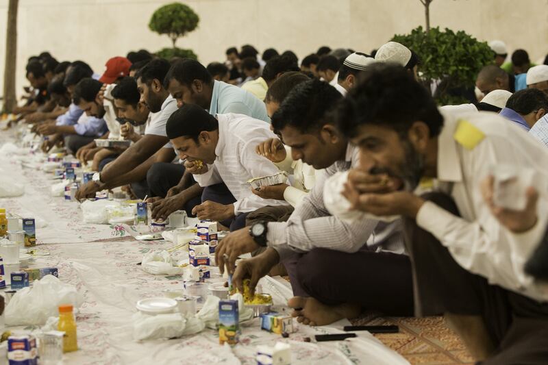 Men break their fast during iftar time ahead of maghrib prayers at the Abdul Rahman Siddik Mosque on the Palm Jumeirah in Dubai. Christopher Pike / The National