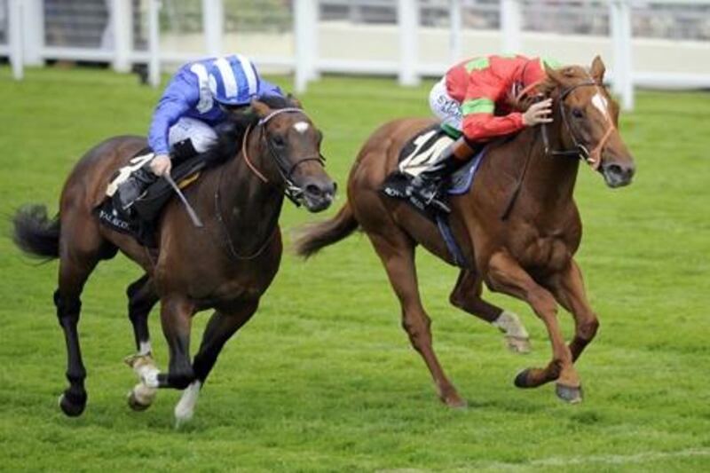Strong Suit ridden by Richard Hughes (right) beats Elzaam ridden by Richard Hills (left) to win the Coventry Stakes on day one of the Royal Ascot Meeting at Ascot Racecourse, Berkshire.
