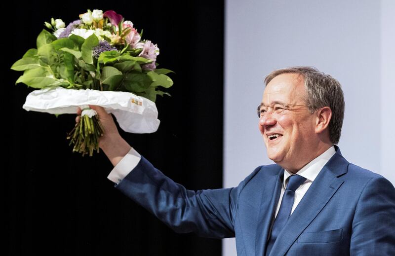 Armin Laschet, State Premier of North-Rhine Westphalia and a leader of the Christian Democratic Union party CDU holds flowers during a CDU party convention in NRW's capital Duesseldorf, Germany, June 5, 2021. Picture taken June 5, 2021. Marcel Kusch/Pool via REUTERS