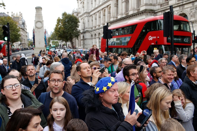 Members of the public wait for the arrival of Mr Sunak near Downing Street. AP