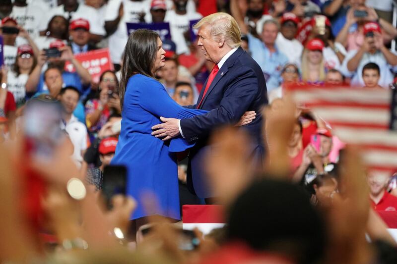 Donald Trump and press secretary Sarah Sanders hug at a campaign kick off rally at the Amway Center in Orlando, Florida.  Reuters