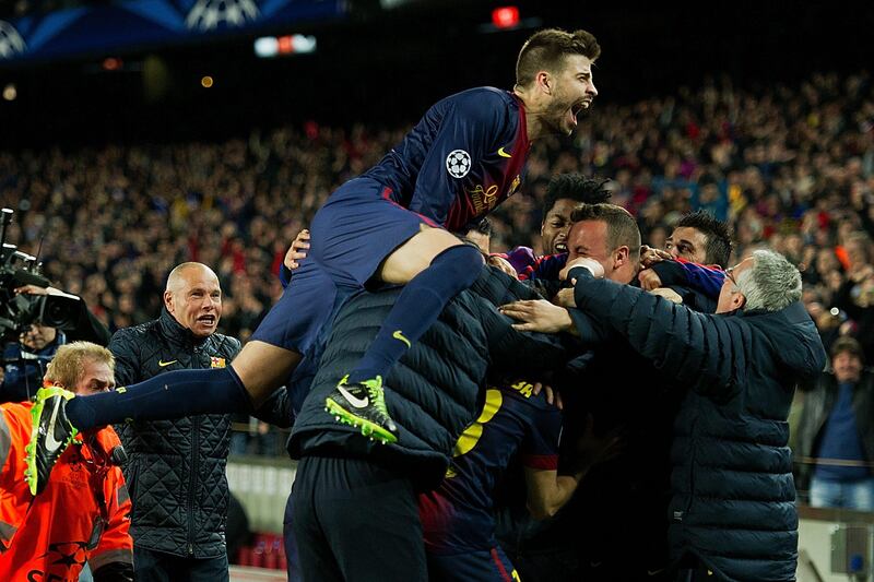 BARCELONA, SPAIN - MARCH 12:  Gerard Pique jumps on to Jordi Alba of FC Barcelona celebrating scoring their fourth goal with technical staff memebers and their temmates Alex Song  and David Villa during the UEFA Champions League Round of 16 second leg match between FC Barcelona and AC Milan at Camp Nou Stadium on March 12, 2013 in Barcelona, Spain.  (Photo by Gonzalo Arroyo Moreno/Getty Images) *** Local Caption ***  163574391.jpg