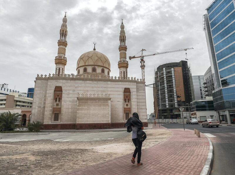 Dubai, U.A.E.,  A woman walks along the Sheikh Hamdan Mosque at Deira during overcast skies and gusty winds.
Victor Besa / The National.
Standalone for Jake Badger.