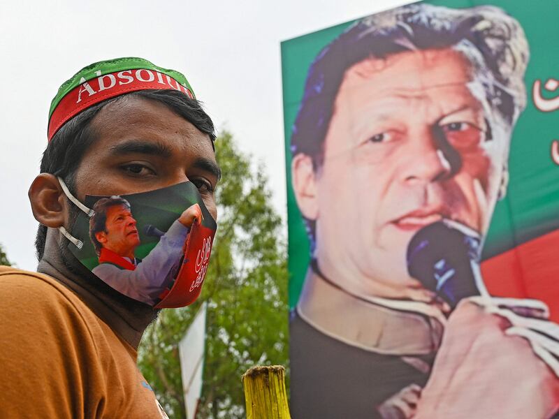 A supporter of Pakistan's former prime minister Imran Khan guards Mr Khan's residence in Lahore on March 17, 2023. AFP