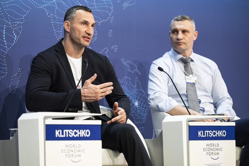 Wladimir Klitschko (L), Ukrainian former professional boxer and businessman, and his brother Vitali Klitschko, Mayor of Kyiv and also a former professional boxer, address a WEF panel session. EPA