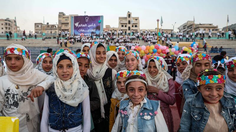 Girls pose together on the pitch during the opening ceremony of the Camps World Cup at the newly reopened Idlib Municipal Stadium in the rebel-held Syrian city. More than 300 children held their own football tournament on Saturday. All photos by AFP