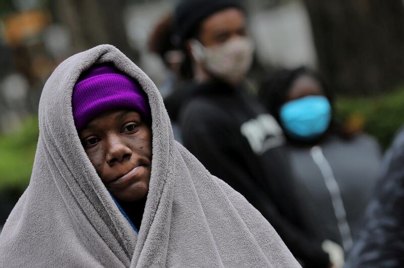 A woman waits in line during a food and clothes distribution for homeless people in downtown Birmingham, Alabama US.  Reuters