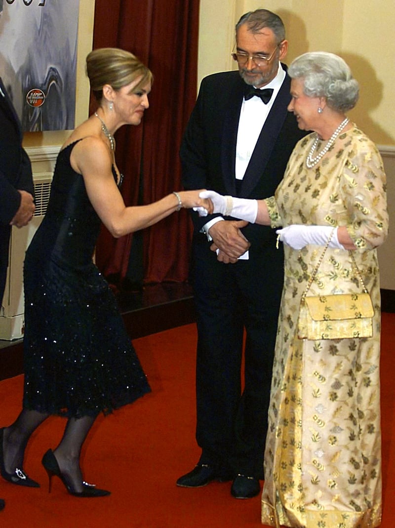 Madonna meets Queen Elizabeth in 2002. PA