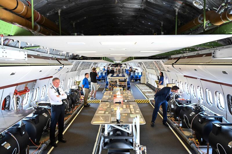 Visitors examine water barrels in a Boeing 777X, in an experiment on weight distribution. AFP