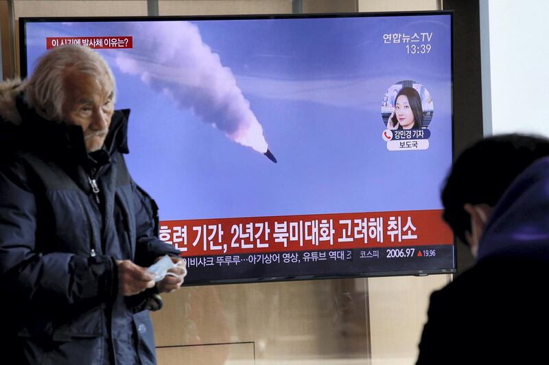 A man walks past a TV showing a file picture for a news report on North Korea firing two unidentified projectiles, in Seoul, South Korea, March 2, 2020.    REUTERS/Heo Ran