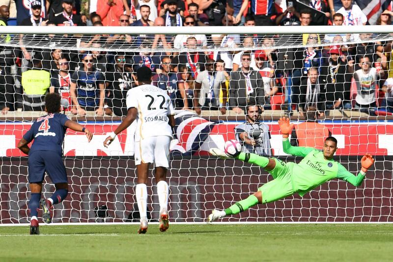 PSG's goalkeeper Alphonse Areola, right, concedes a penalty. AFP
