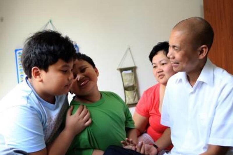 ABU DHABI - 18MAY2011 - Rhoniel Romano (R) with his wife Jocelyn Romano play with their two sons Atreyu 10 years old and Noah 5 years old seeing them after three years at they residence in Abu Dhabi. Ravindranath K / The National