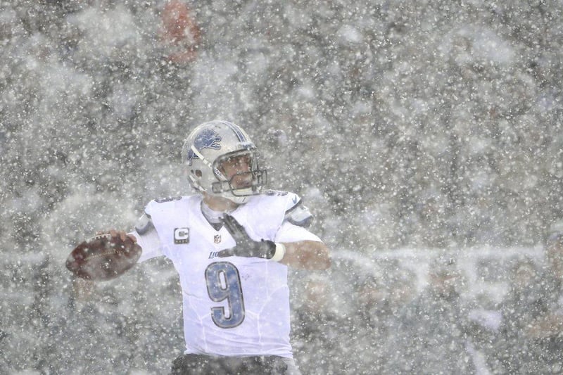 Detroit Lions quarterback Matthew Stafford attempts to throw through the snowfall. The Eagles and Lions struggled in the conditions at first but eventually Philadelphia won, 34-20. Matt Rourke / AP