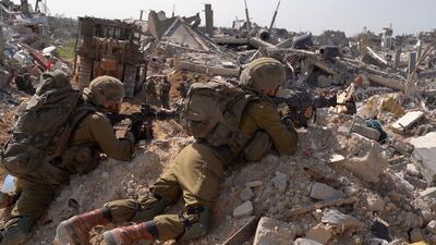 Israeli soldiers operate amid the ruins of buildings in Gaza. Reuters