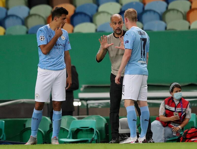 Manchester City's coach Pep Guardiola speaks to his players. AP