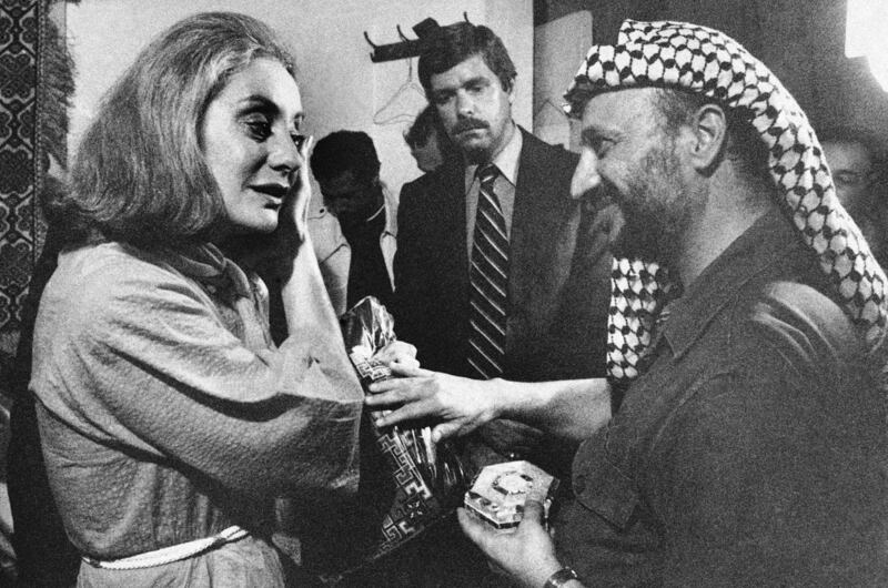 Palestinian leader Yasser Arafat, right, presenting ABC's Barbara Walters with a handmade dress and mother of pearl box following an interview with him in Beirut in September 1977. AP Photo