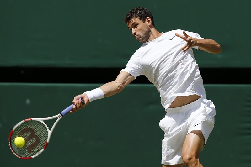 Grigor Dimitrov returns to Andy Murray during his victory in the quarter-finals at the 2014 Wimbledon Championships on Wednesday. He faces Djokovic in the semi-finals. Andrew Cowie / AFP