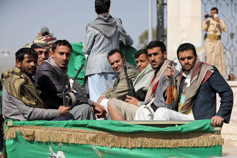 FILE PHOTO: Armed Houthi followers ride on the back of a truck after participating in a funeral of Houthi fighters killed in recent fighting against government forces in Yemen's oil-rich province of Marib, in Sanaa, Yemen February 20, 2021. REUTERS/Khaled Abdullah/File Photo