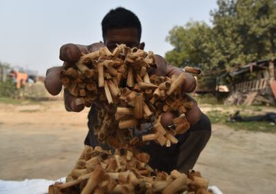A worker sifts through cigarette butts at the Code Effort factory. Taniya Dutta for The National
