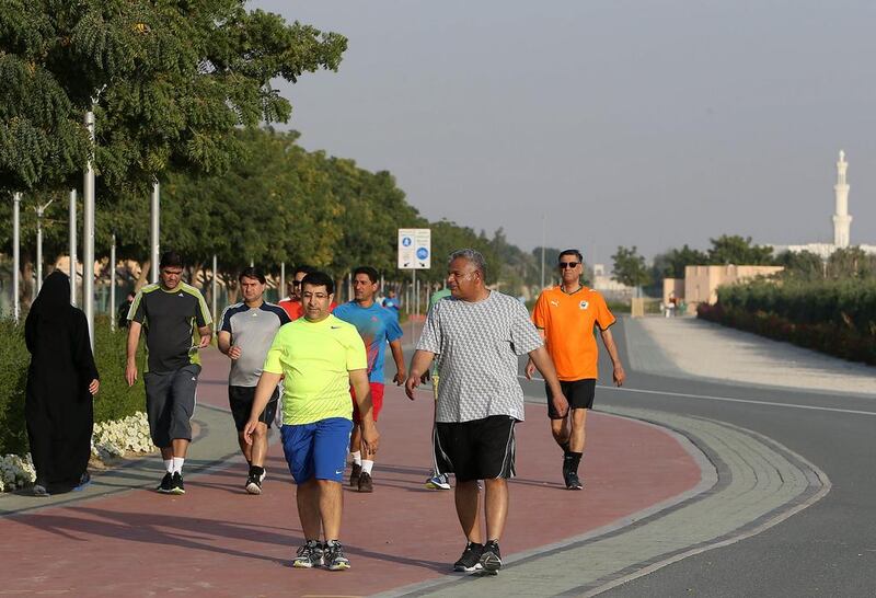 People walking and jogging at the Quran Park in Al Khawaneej area in Dubai last month.  Pawan Singh / The National 