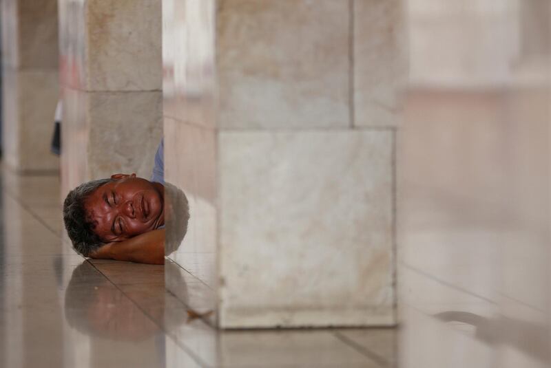 A Muslim man rests while waiting for Friday prayers at Istiqlal Mosque in Jakarta. Willy Kurniawan / Reuters